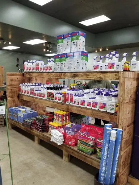 Shelves of insect sprays, weed killers and plant food in the KBK Garden Center shop
